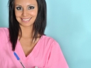 Attractive young medical assistant in scrubs